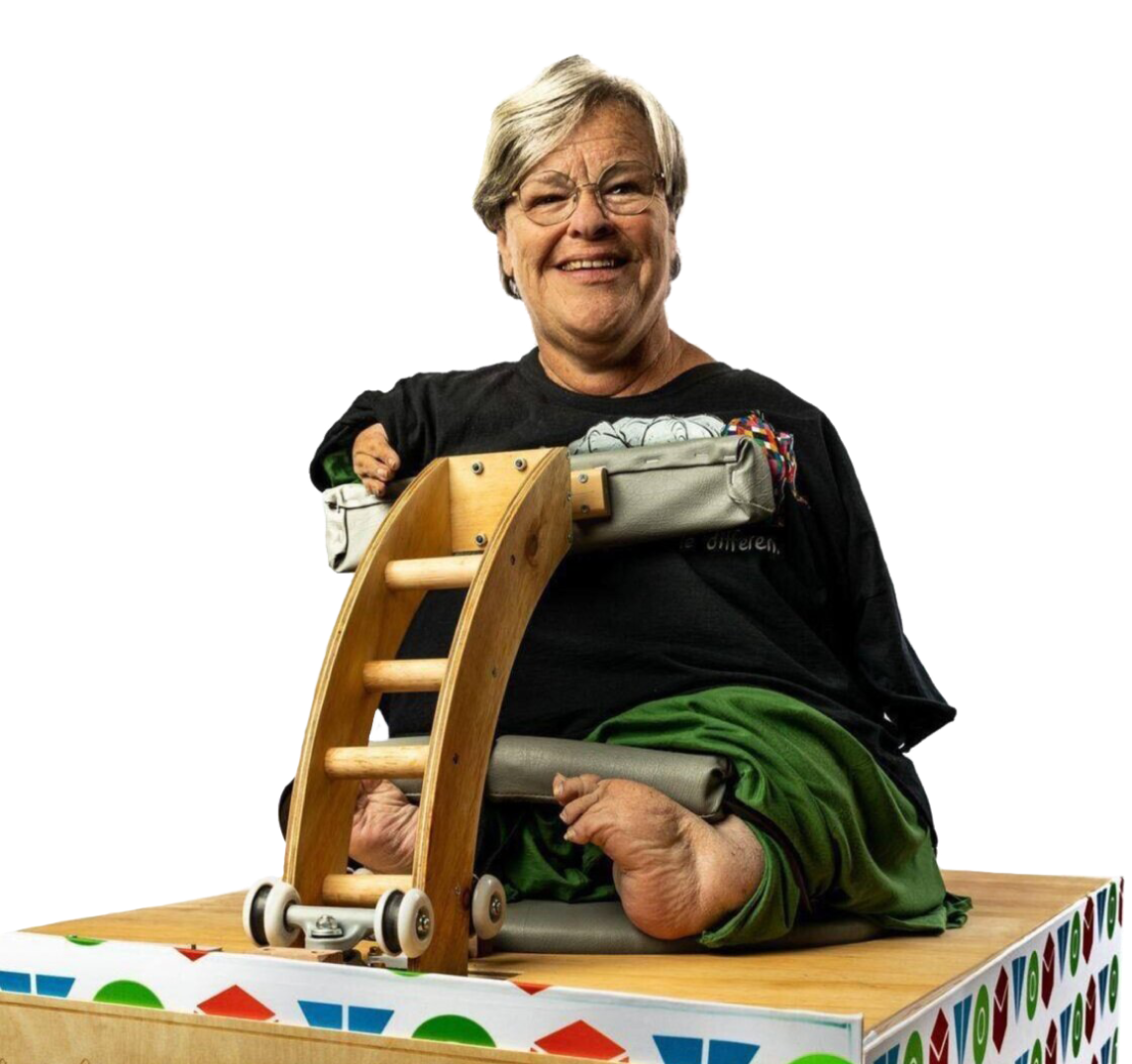 Woman in black t-shirt smiling to the camera on top of a workout device.