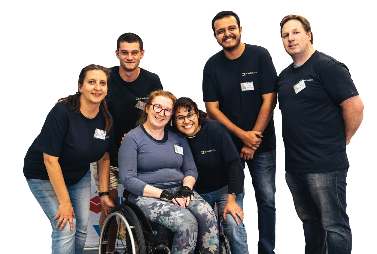 Six people smiling to the camera as a group.