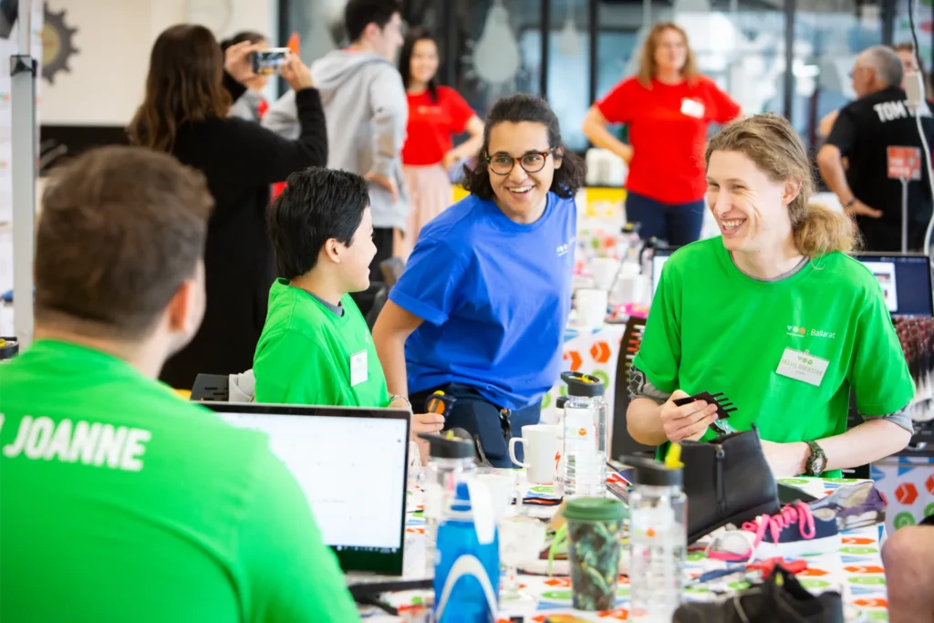 A group of volunteers laughing in a workshop.