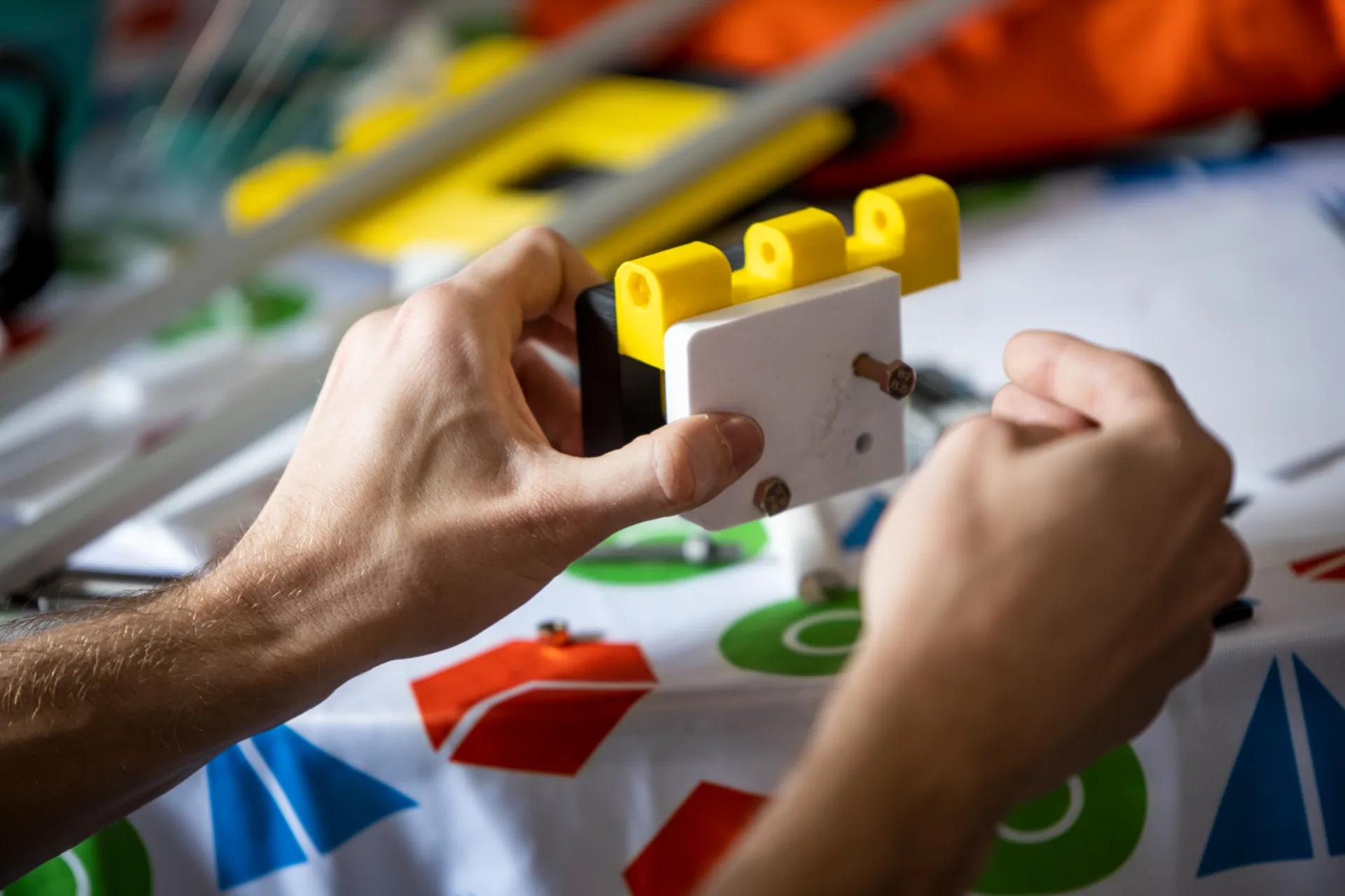 Close up of hands screwing in a screw.