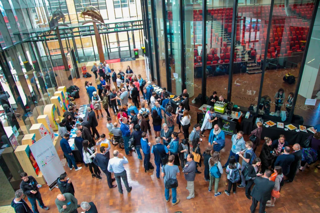 Overhead view of a large room with people mingling.