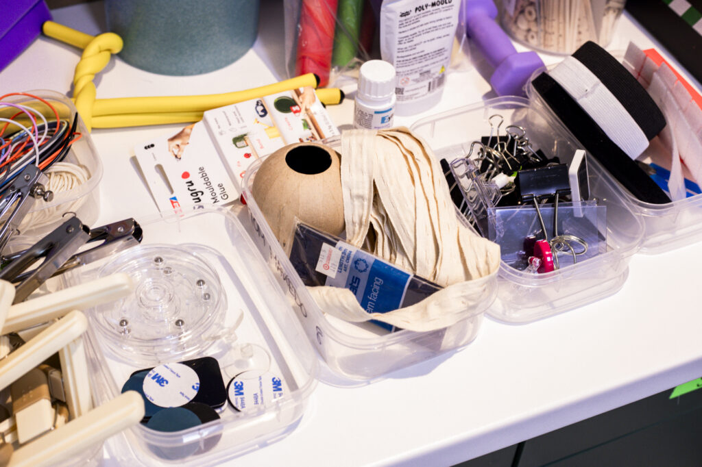 Prototyping supplies sorted in boxes on a table.