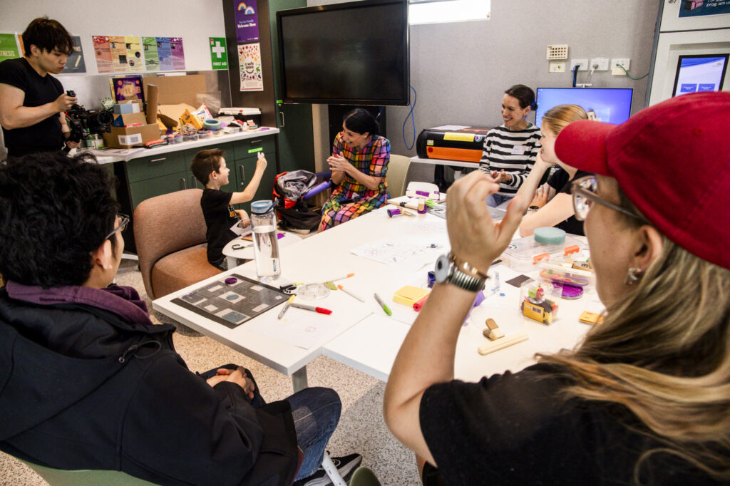 People around a conference table is cheering and smiling.