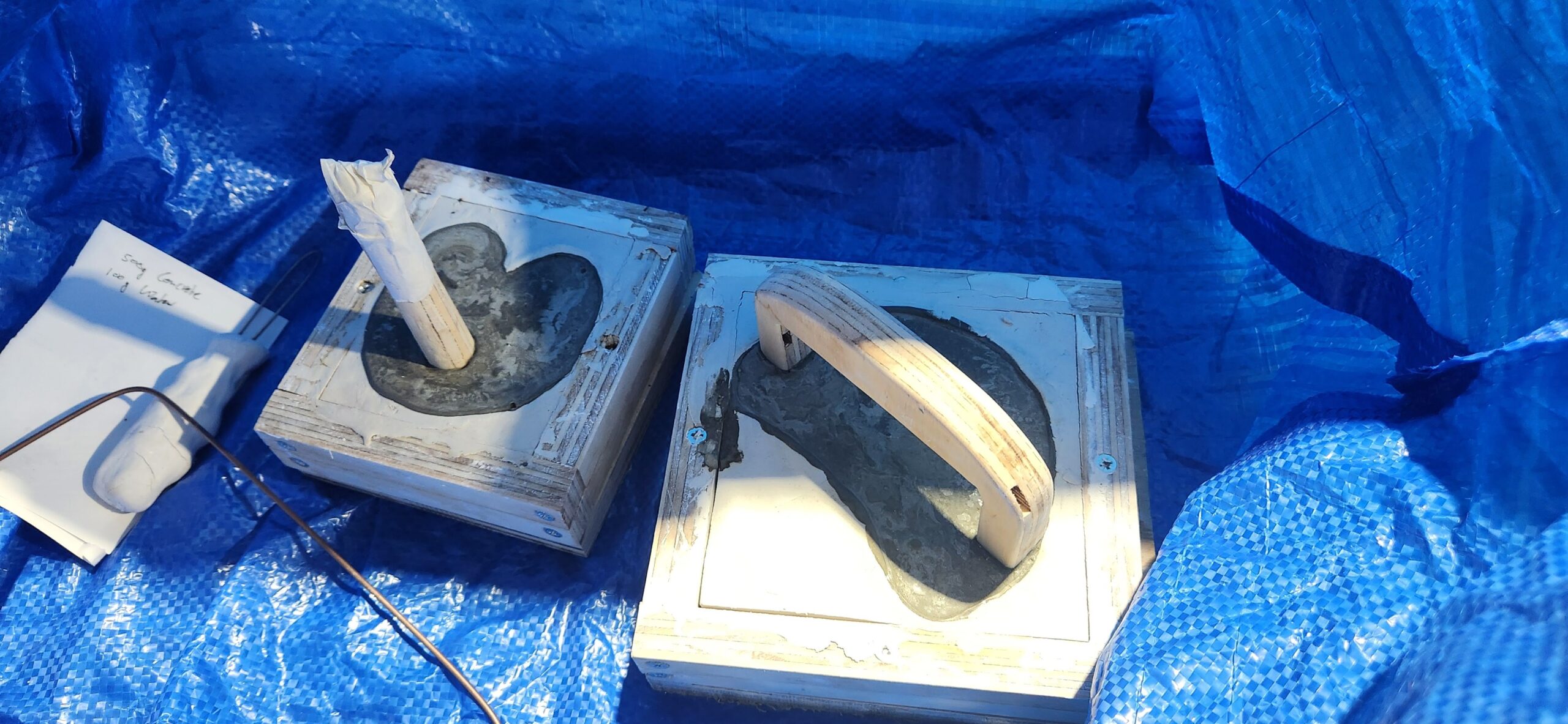 2 concrete casts in moulds sitting in a blue ikea bag.