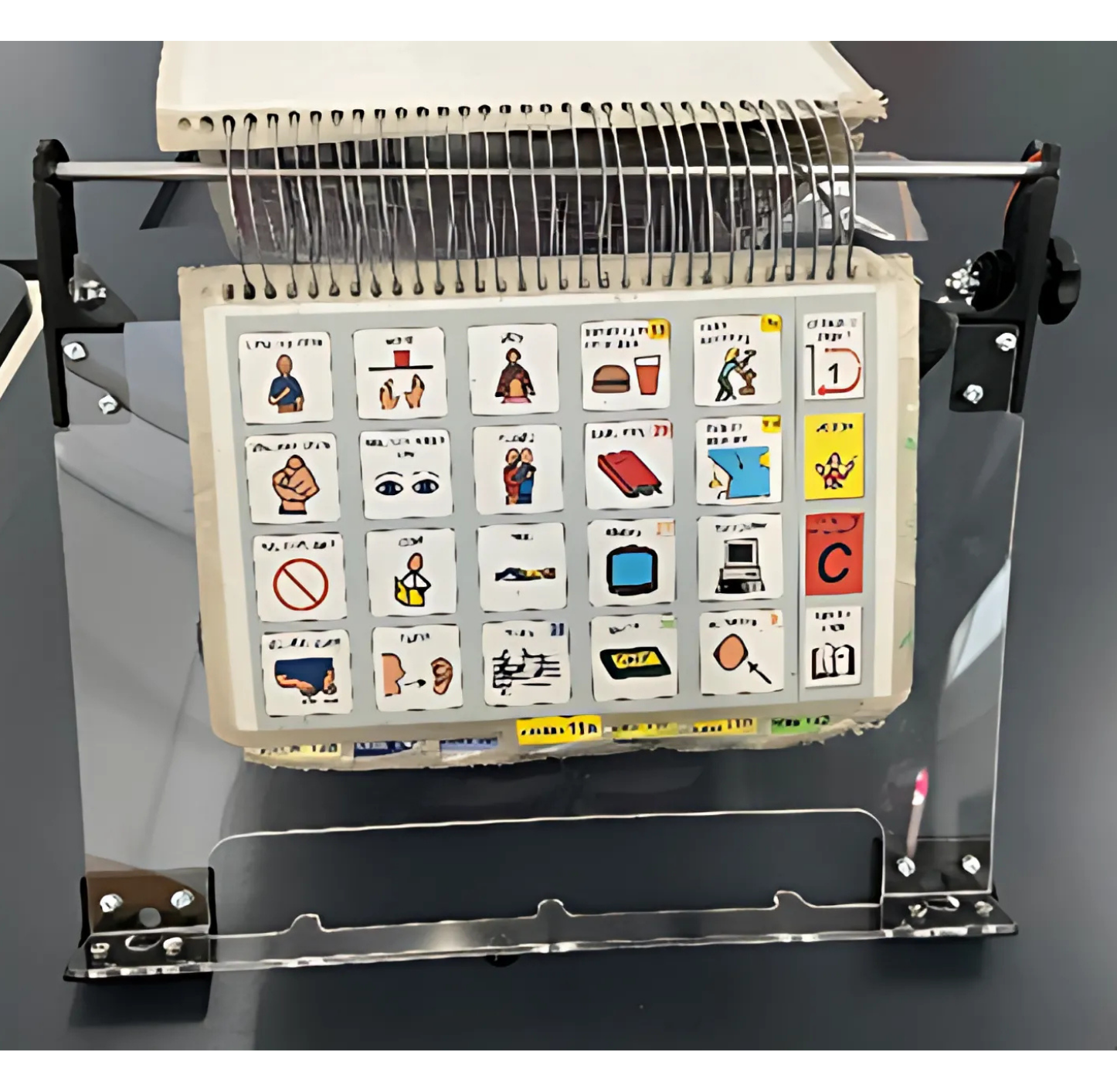 A5 landscape PODD book being displayed on the communication book stand prototype
