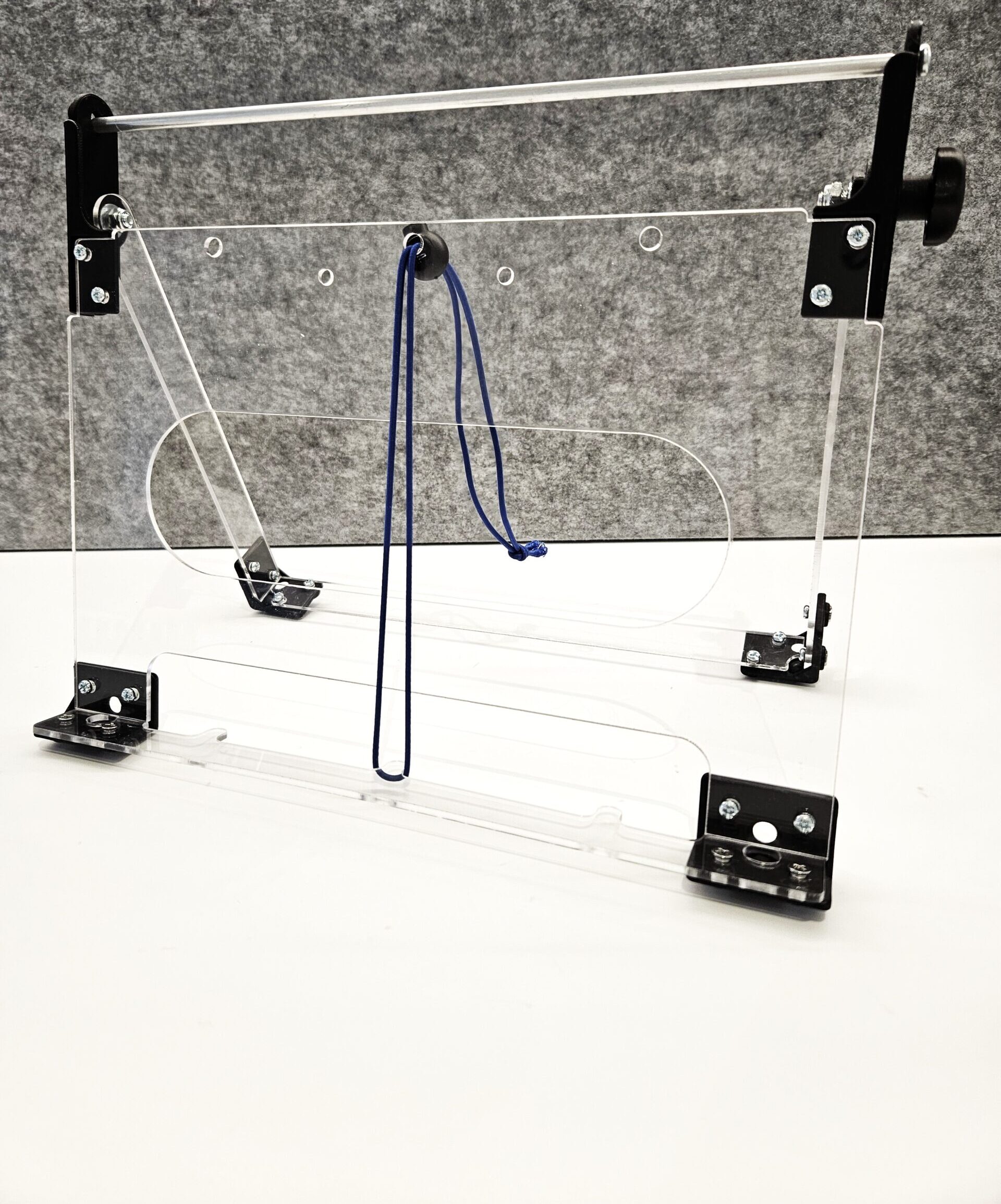 Communication book stand made out of clear plastic and black metal.