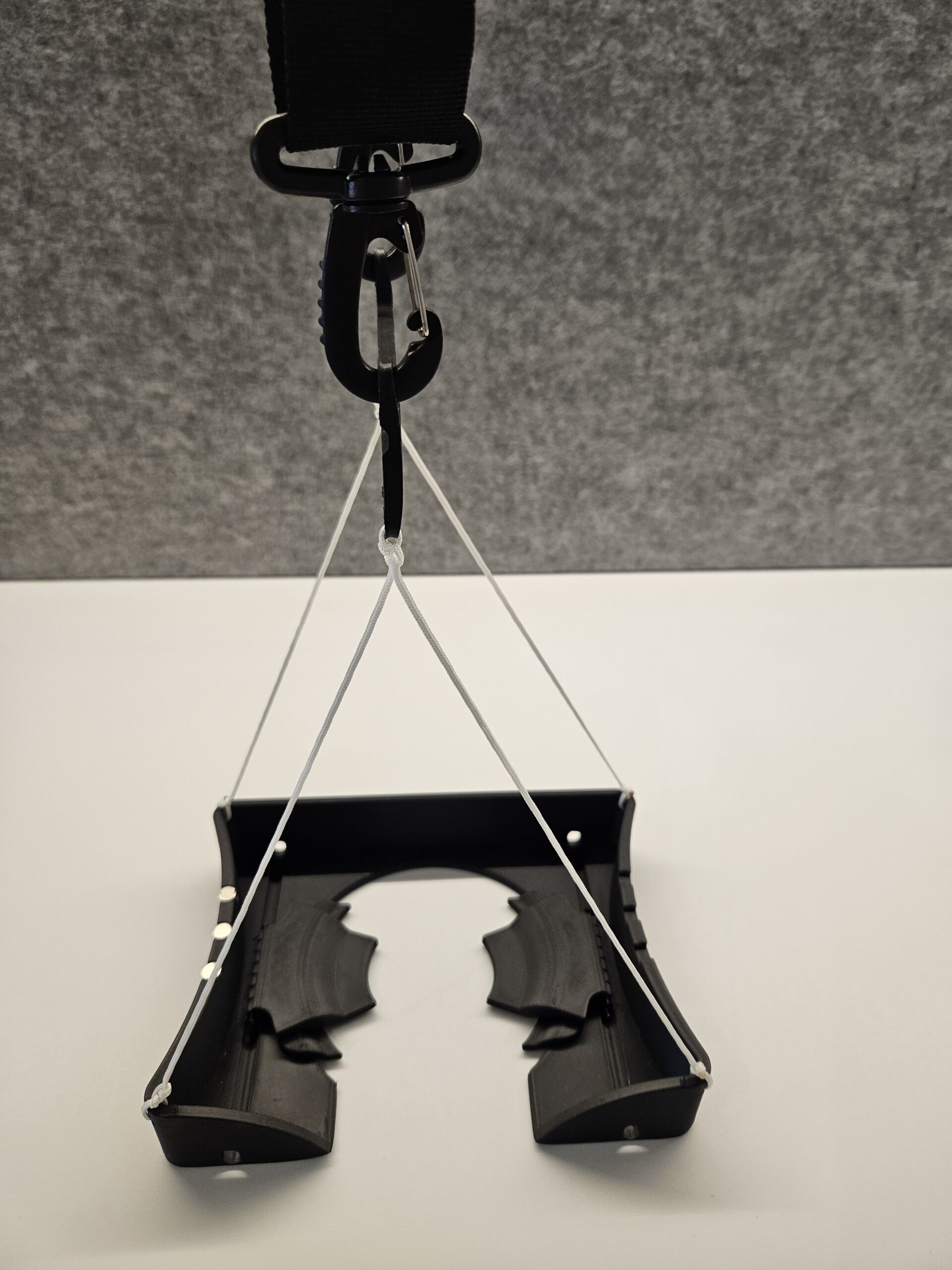 Close up view of the lifting platform of the Lawn Bowls Aid, suspended by the shoulder strap