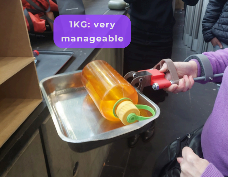 Person holding the prototype and a 1 kg weight.