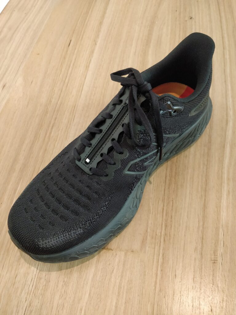 Black shoe with the shoelace insert laced into the laces.